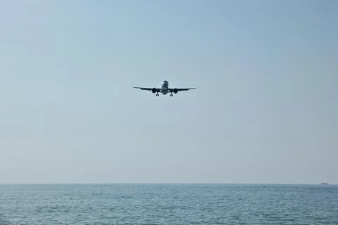 Front View of Jet Passenger Plane Flying Over the Sea Stock Photos
