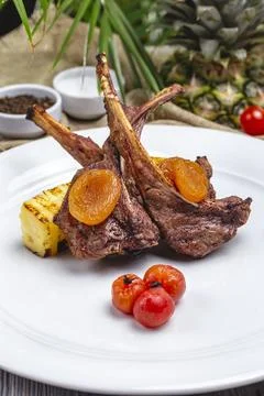 Front view lamb ribs kebab with dried apricots and cherry tomatoes Stock Photos
