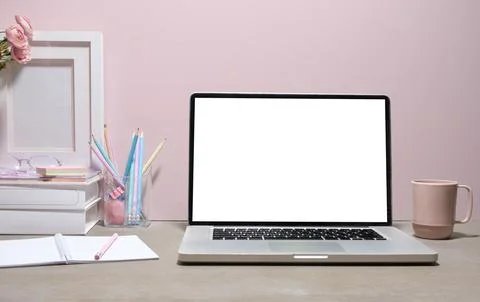 Front view of laptop with blank screen, books and stationery on women worki.. Stock Photos