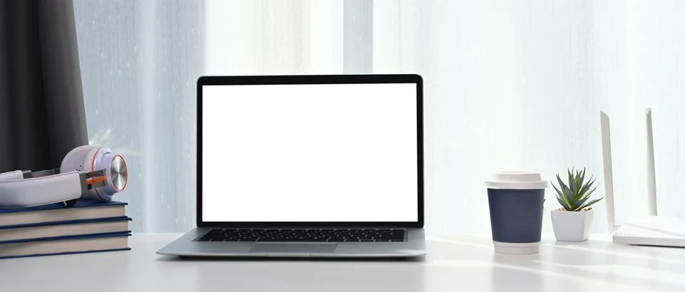 Front view of laptop computer with blank screen and wireless internet router  Stock Photos