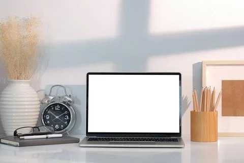 Front view laptop computer with blank screen, picture frame, alarm clock, not Stock Photos