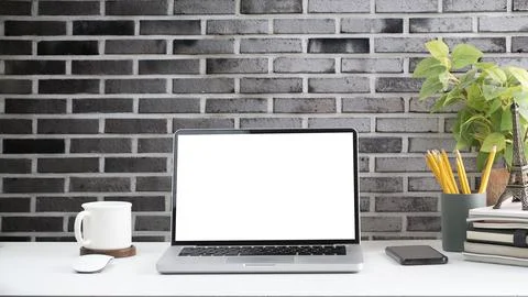 Front view laptop computer, coffee cup, stationery and houseplant on white .. Stock Photos