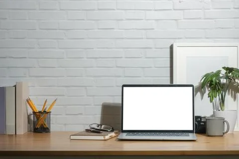 Front view of laptop computer with empty display, picture frame and station.. Stock Photos