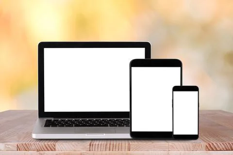 Front view of the laptop, tablet pc, smartphone is on the work table with b.. Stock Photos