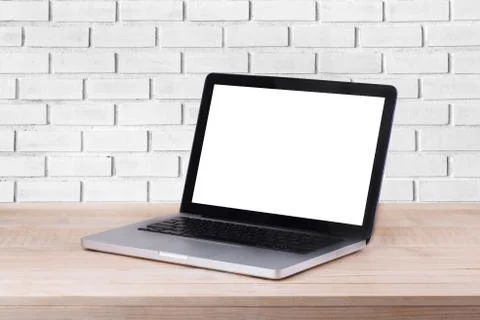Front view of the laptop is on the work table and white brick background Stock Photos