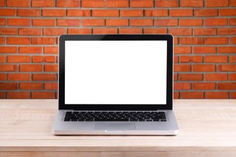 Front view of the laptop is on the work table brick background Stock Photos