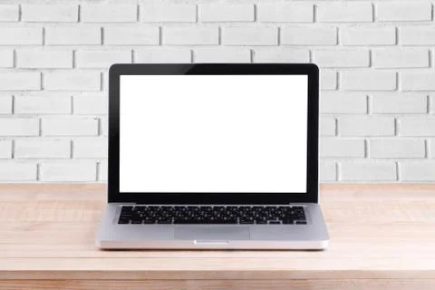 Front view of the laptop is on the work table brick background Stock Photos