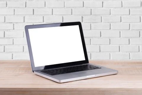 Front view of the laptop is on the work table brick background Stock Photos