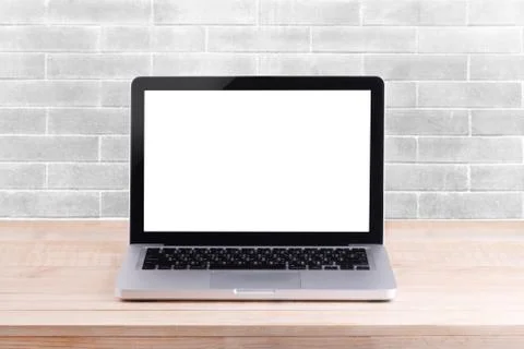Front view of the laptop is on the work table white brick background Stock Photos