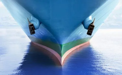 Front view of large blue Ro-Ro cargo ship in the middle of the ocean. Perform Stock Photos