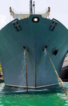 Front view of a large warship at the river roadstead. Black anchors stick out Stock Photos