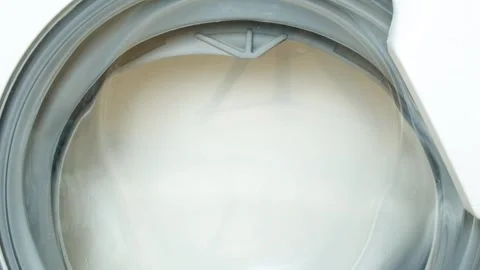 Front view of laundry washer in process of cleaning clothes slow motion Stock Footage 327802128