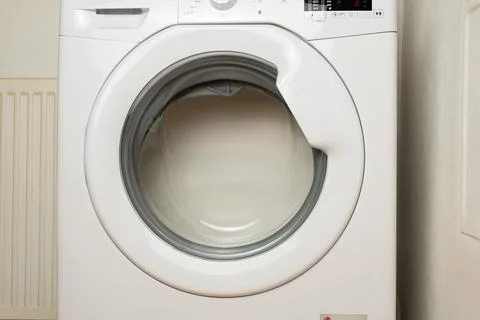 Front view of laundry washer in process of cleaning clothes Stock Photos
