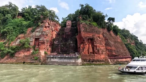 Front view of Leshan Giant Buddha from river with tour boats Stock Footage 315582795