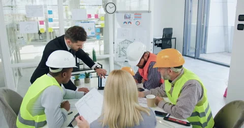 Front view of likable confident professional mixed races team of builders which Stock Footage 145805749