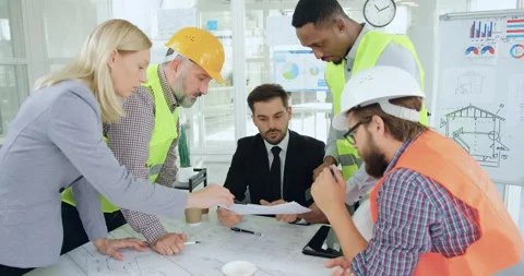 Front view of likable purposeful skilled multiethnic team of builders which Stock Footage 145610089