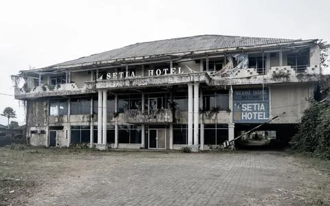 Front view of the long-abandoned Hotel with eerie atmosphere. Photos