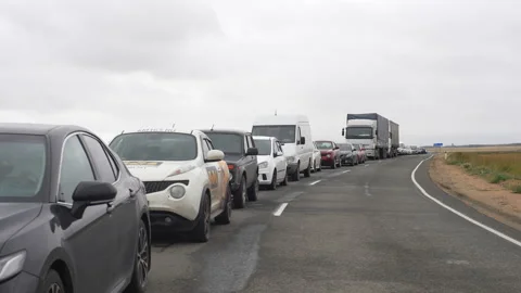 Front view of long queue of cars waiting in large traffic jam at customs border Stock Footage 222134261