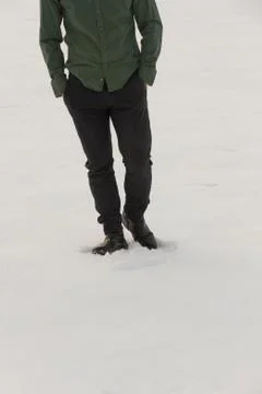 Front view of lower body half dressed man walking in the snow with his hands Stock Photos