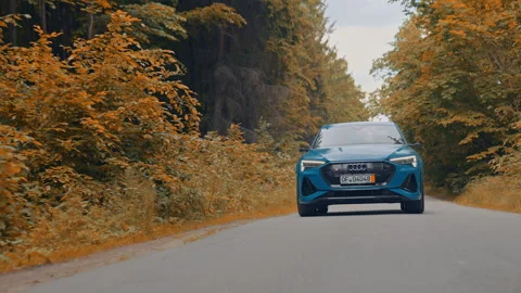 Front view of a luxury car moving on the road in daylight. New electric car audi Stock Footage 160096908