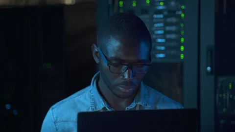 Front view of male engineer working with laptop and posing, sitting at table in Stock Footage 160806776