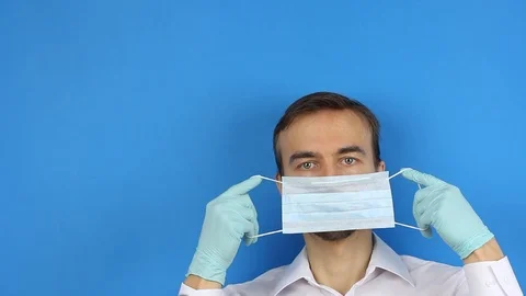 Front view on male face, put on medical mask, prevention or protection of virus Video stock 126998906