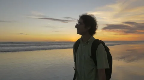 Front view of a man enjoying the ocean sunset view in Bali Stock Footage 63117978