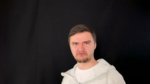 Front view of man expressing emotion of disgust, detestation, revulsion, nausea Stockbeeldmateriaal 192059578