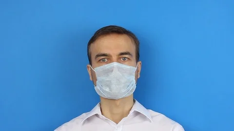 Front view man face in center, remove medical mask, finish epidemic quarantine Stock-Footage 126998920
