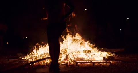 Front view of man jump a bonfire . slowmotion Stock Footage 277351635