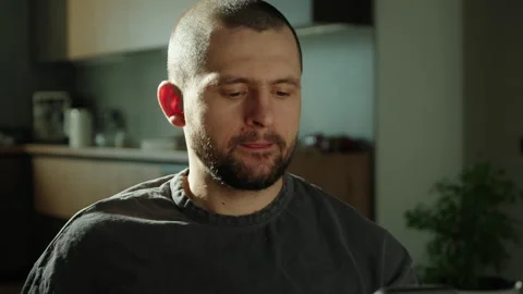 Front view of a man in the kitchen having breakfast and drinking a cup of tea Stock Footage 273304789