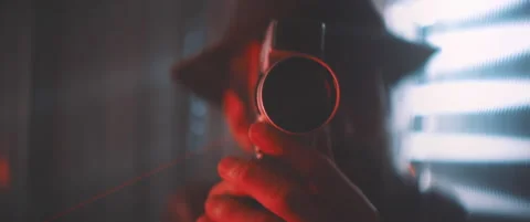 Front view of man looking into vintage camera in red lights Stock Footage 203563255