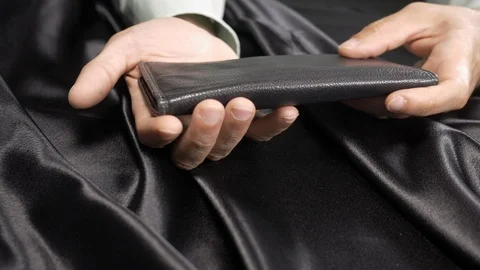 Front view. man playing with his fancy leather wallet. 4k. Stock Footage 96001897
