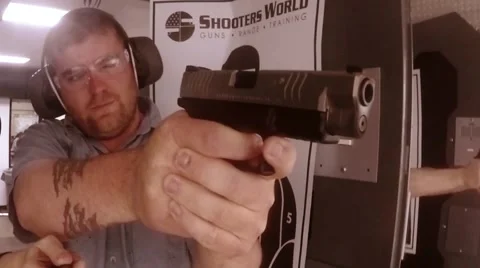 Front view man shooting pistol at range Video stock 61094293