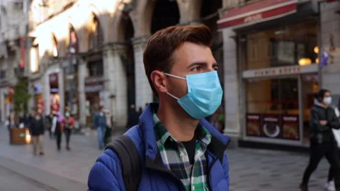 Front view of a man with short brown hair out and about in the city streets Stock Footage 143973674