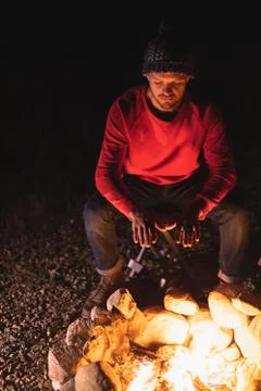 Front view of man warming by the fire Fotos Stock