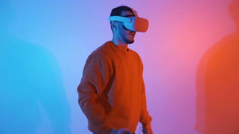 Front view of a man wearing a VR Virtual headset, in a fighting pose Stock Footage 144002225