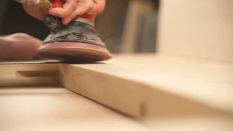 A front view of man's hand holding pneumatic power sander to polish Stock Footage 103367338