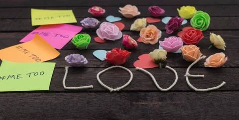 Front view of Me too message written in colorful stickers on a love knoted ba Stock Photos