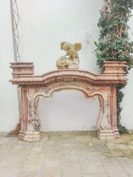 Front view, medium distance of a pink marble,fireplace against an interior stone Fotos de archivo