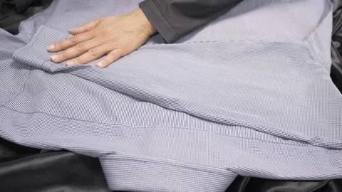Front view-merchandiser folding a brand name luxury businessman dress shirt 4 Stock Footage 96292008