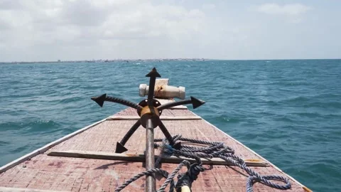 Front view of metal boat anchor resting on wooden deck of vessel sailing ac.. Stock Footage 337644774