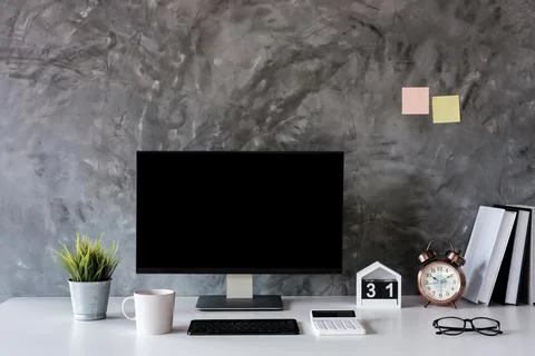 Front view of Mock up computer and office supplies gadget. Blank screen for Stock Photos