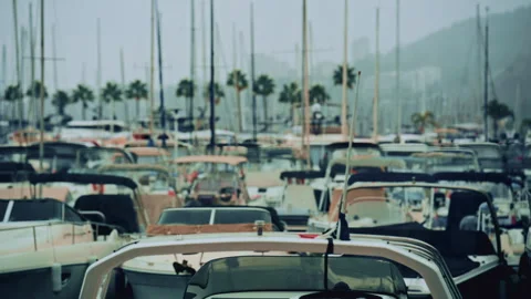 Front view of a modern motorboat docked in a busy marina filled with yachts, Stock Footage 322901658
