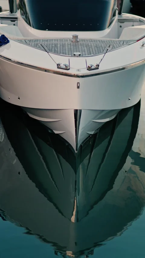 Front view of modern white luxury yacht docked in calm harbor water, perfec.. Stock Footage 339374092
