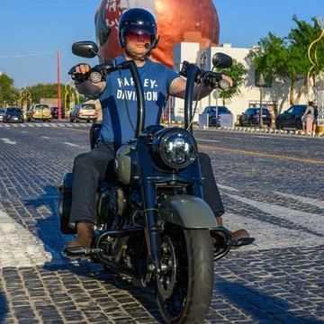 Front view of a motorcyclist wearing a helmet and protective gear. Stock Photos