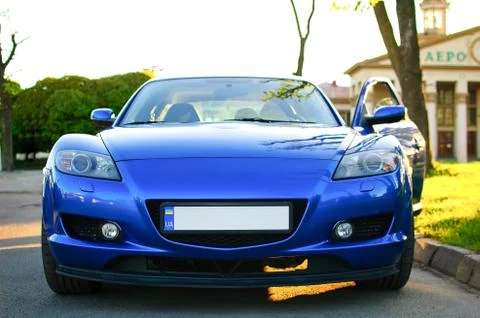 Front View of New Clean Blue Sport Car with Opened Door Parked on the Street Foto stock