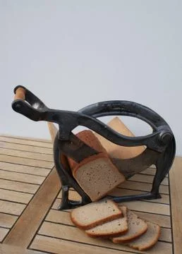 Front view of a nostalgic bread slicer with cutting bread Stock Photos