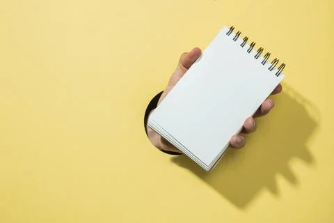 Front view notebook with yellow background. High quality beautiful photo co.. Stock Photos