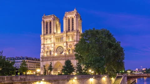 Front view of Notre Dame De Paris cathedral day to night timelapse after sunset. Stock Footage 241347533